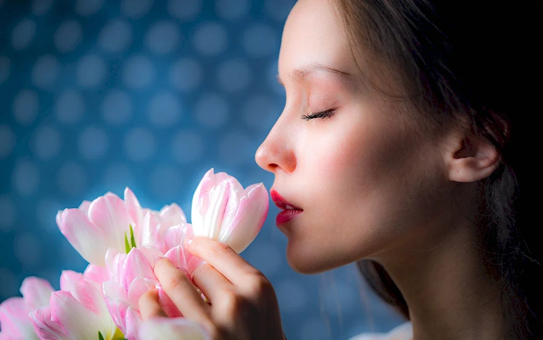 Девушка нюхает цветы